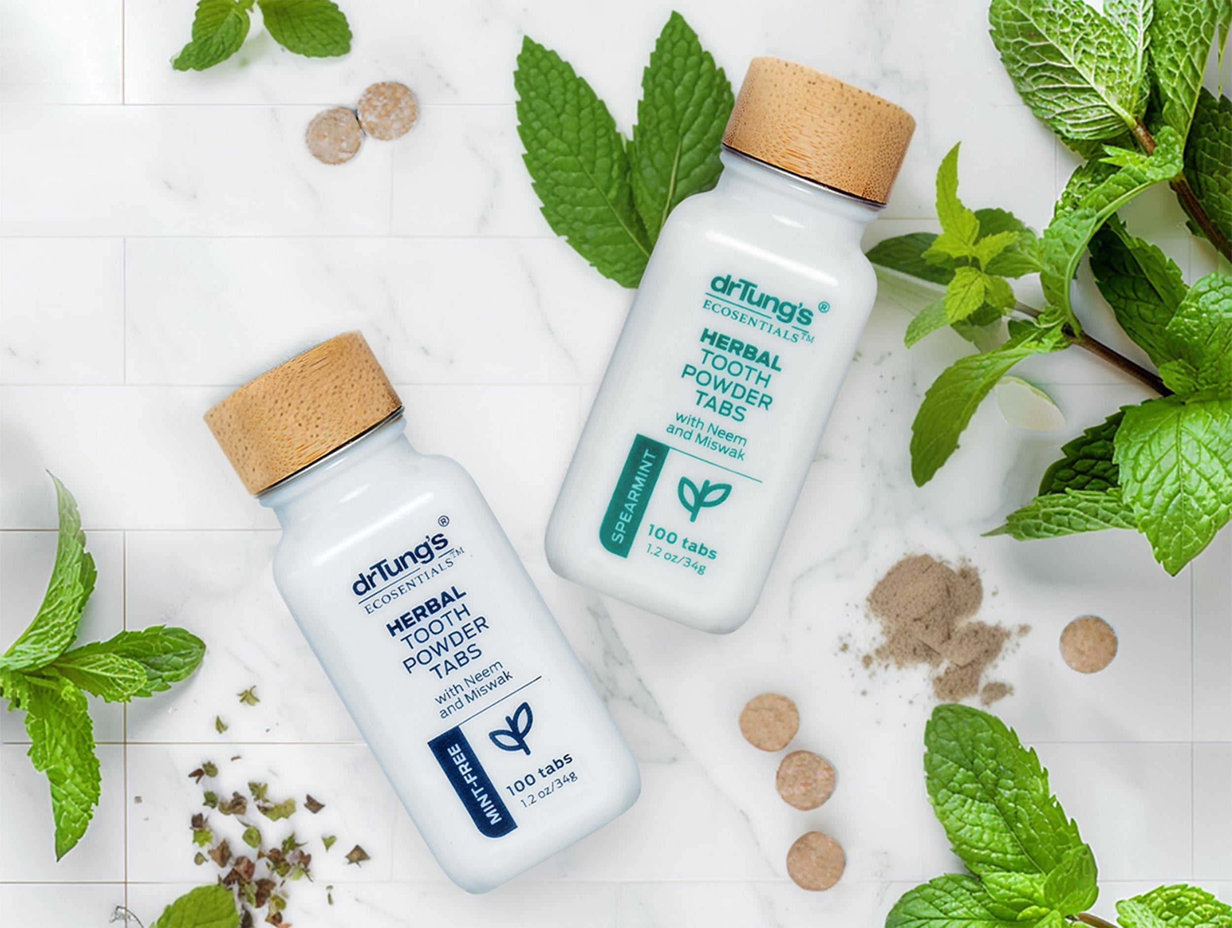 Herbal Toothpowder tabs with mint leaves on a table