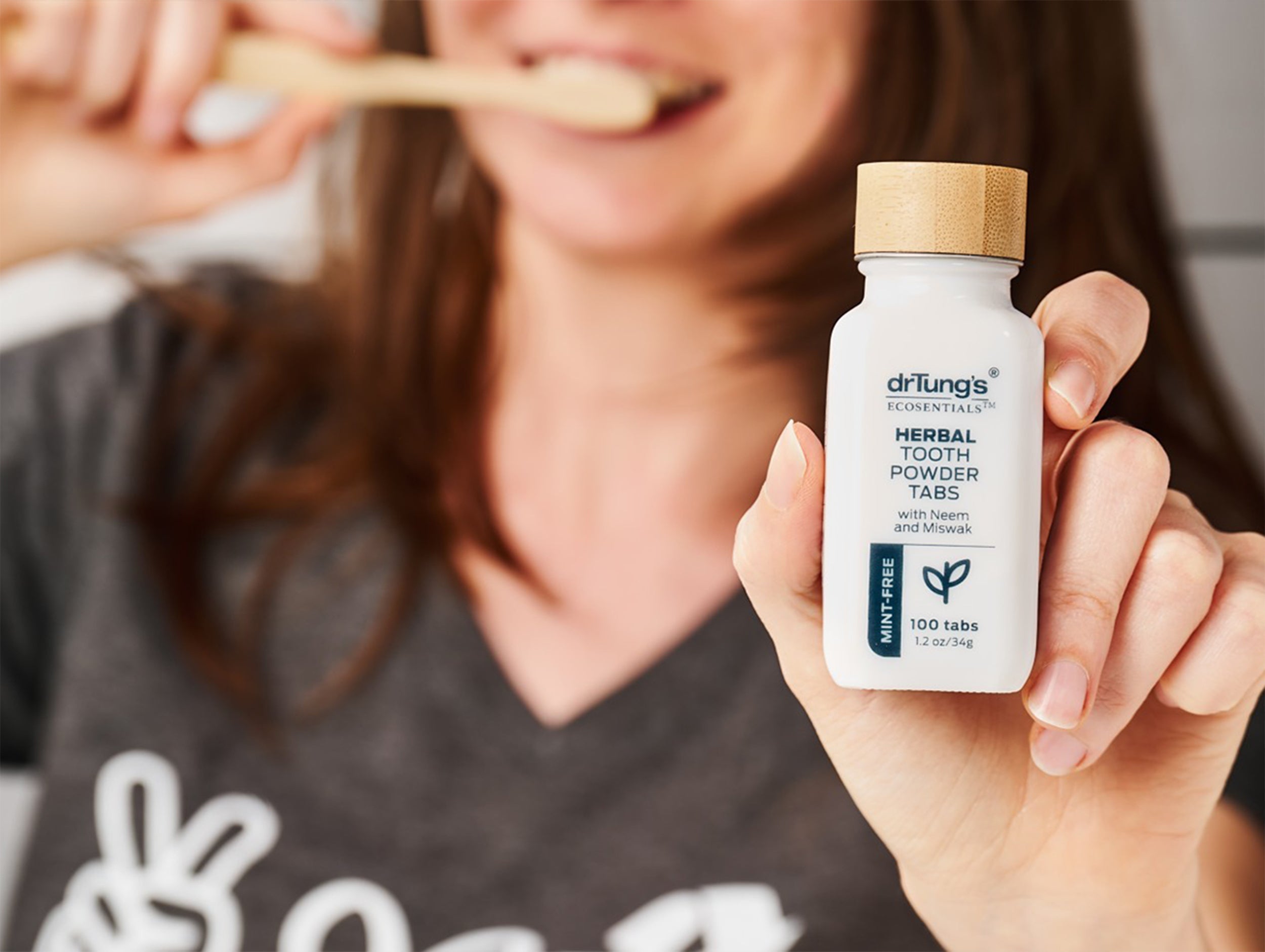 A woman showing the herbal toothpowder tabs mint-free