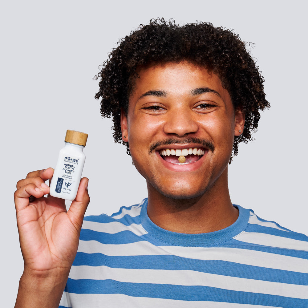 Guy holding Herbal Toothpowder Tabs Mint-Free - DrTung’s
