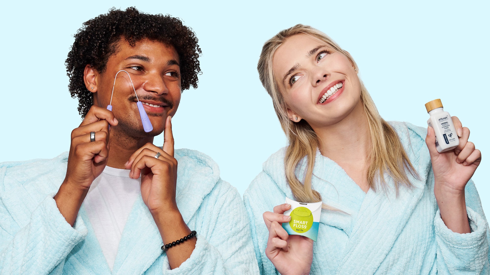 Two people in bathrobes using skincare products against a light blue background